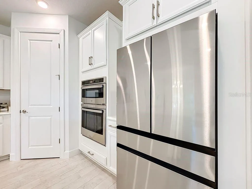 Stainless Steel Built-in Microwave/Oven Combo, Samsung Refrigerator with interior ice maker, water fill, and Large Pantry