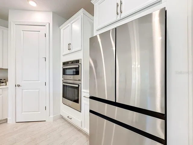 Stainless Steel Built-in Microwave/Oven Combo, Samsung Refrigerator with interior ice maker, water fill, and Large Pantry