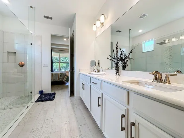 Primary Bath with Upgraded Cabinets and Quartz Counters, Linen Closet, and Private Water Closet.