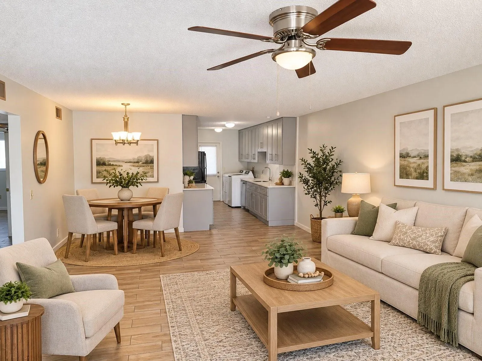 View of the living/dining and kitchen areas from the entrance, Virtually enhanced.