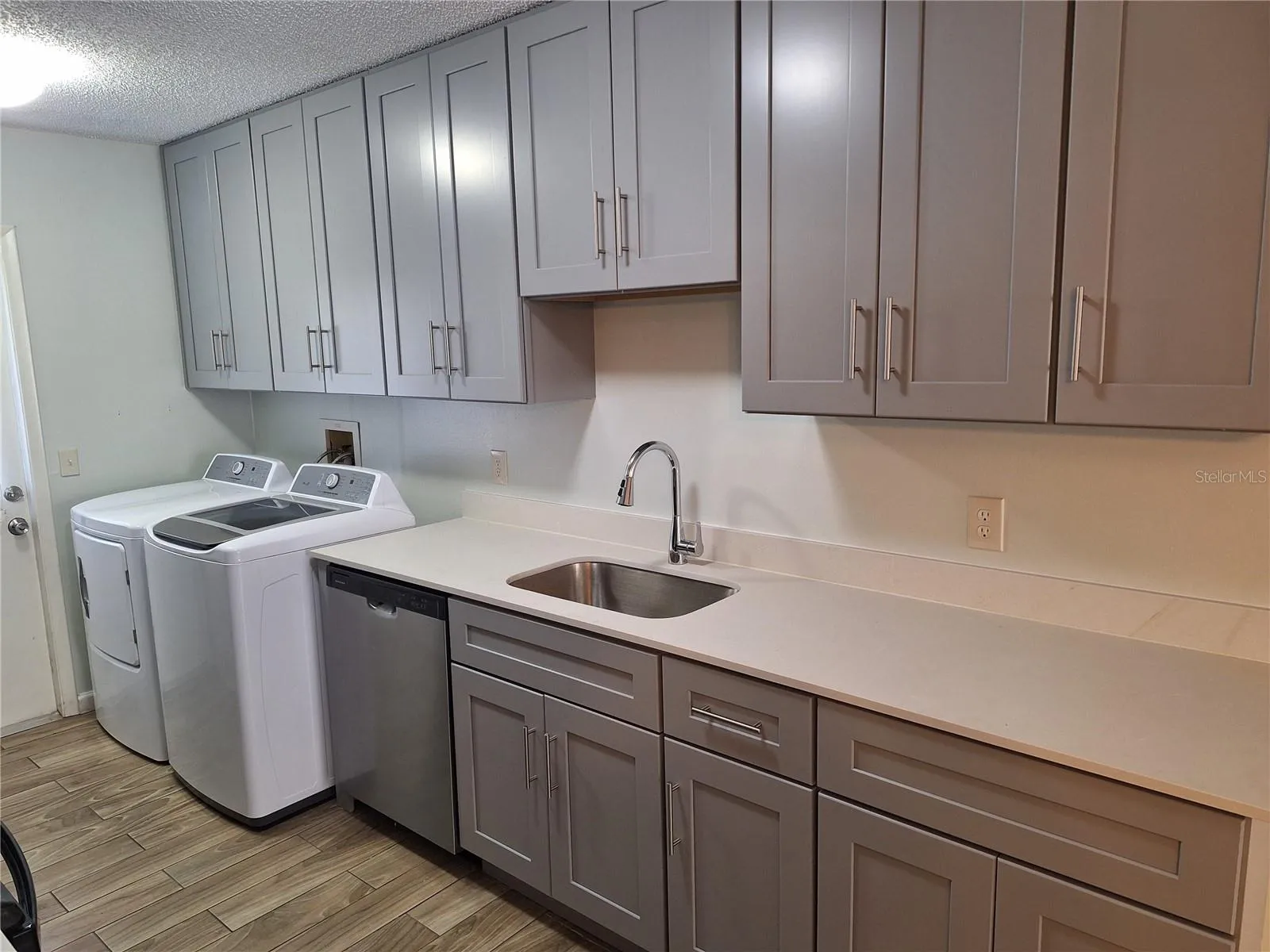 View of kitchen showing cabinet space and washer and dryer!
