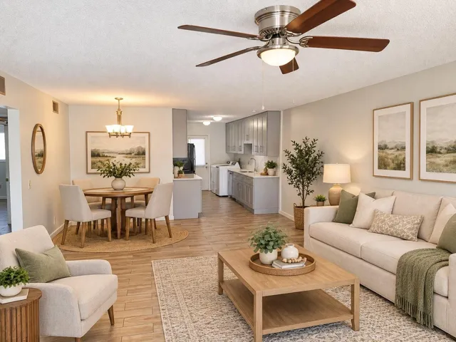 View of the living/dining and kitchen areas from the entrance, Virtually enhanced.