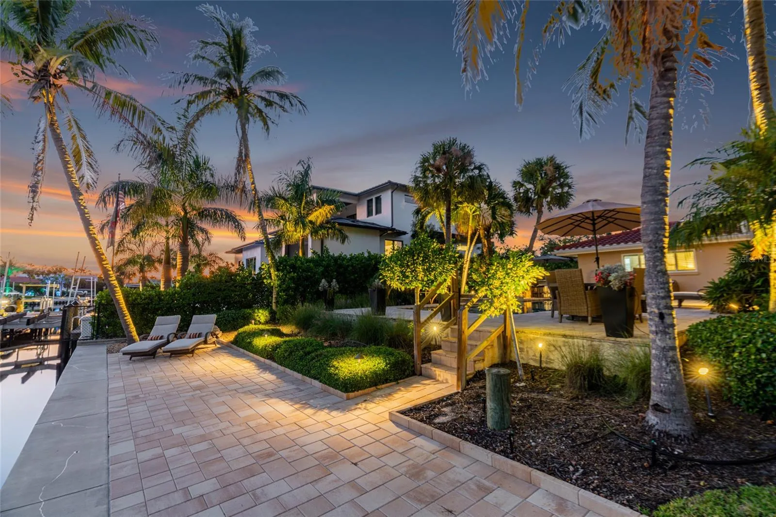 Waterfront Terrace Twilight, highlighting the connection to the water and Siesta Key lifestyle.