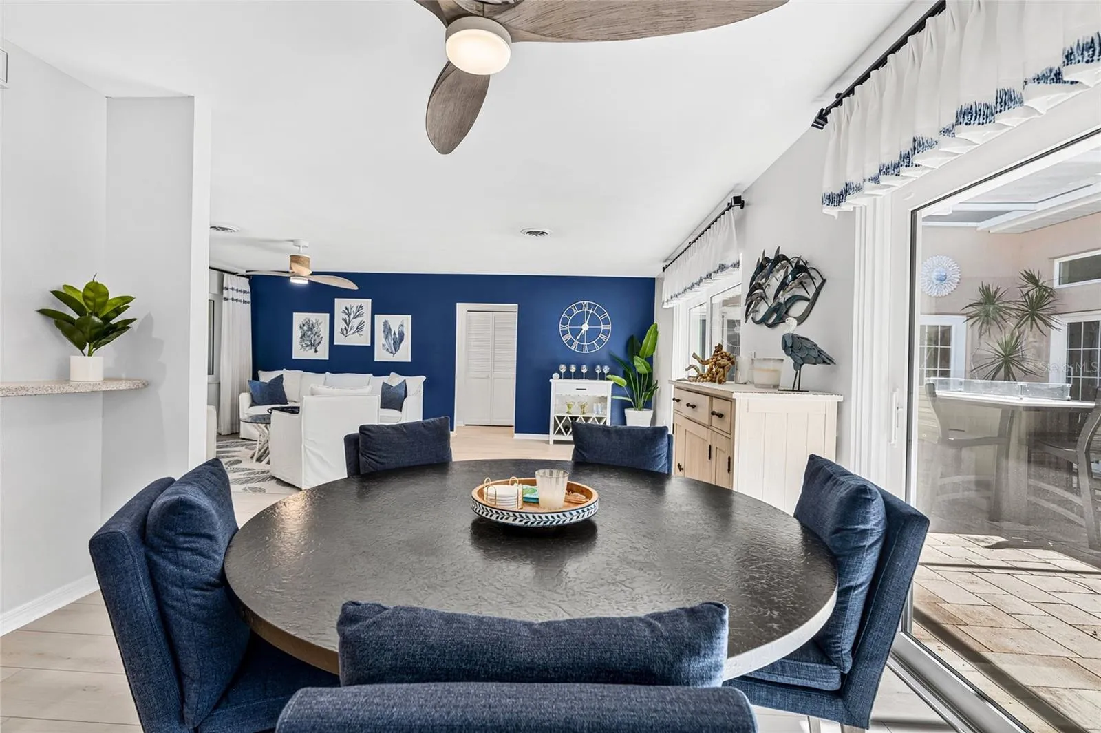 Dining area overlooks the screened courtyard lanai, creating an easy connection between indoor and outdoor living.