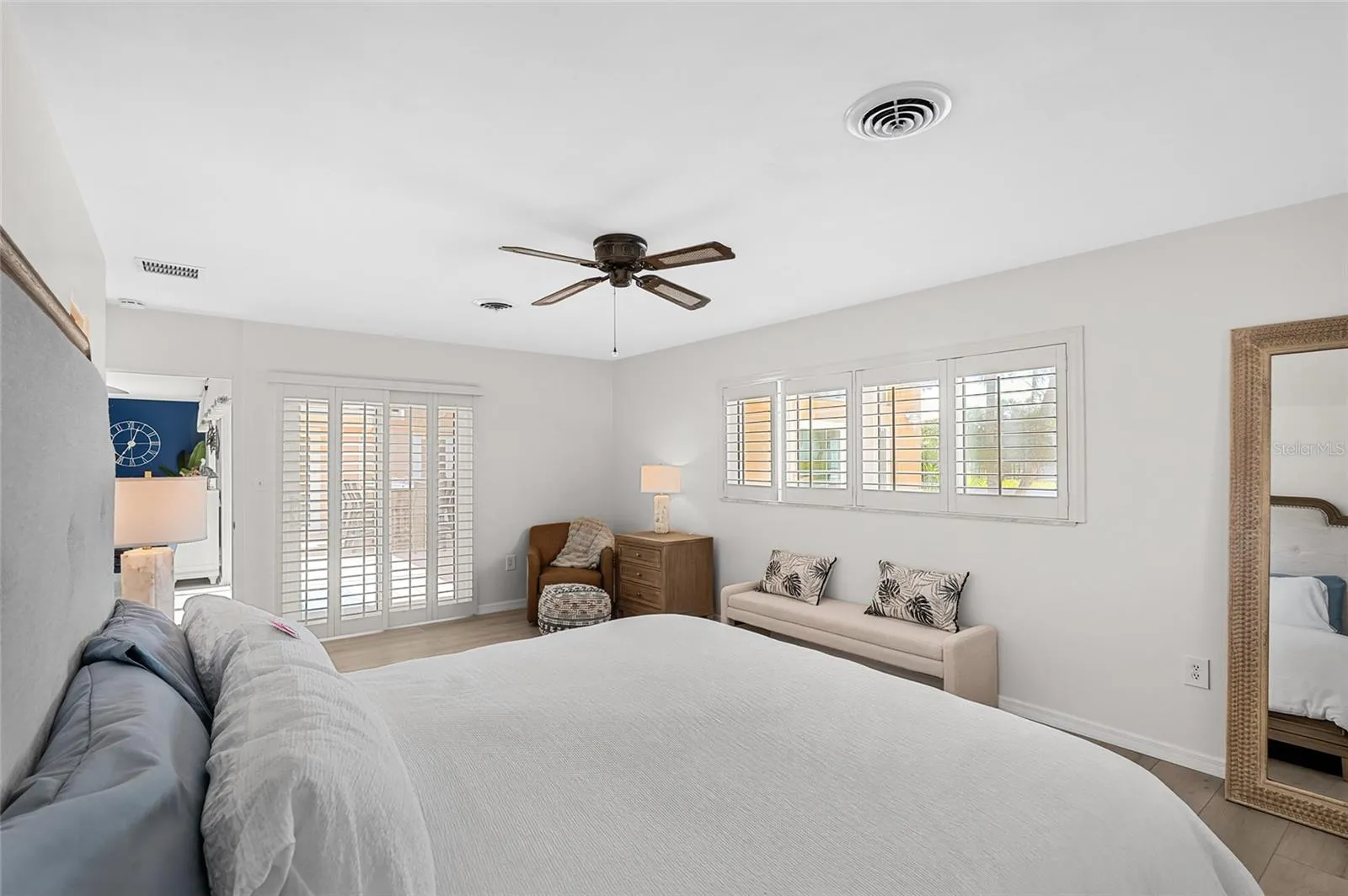 The first floor primary suite offers comfortable proportions, direct courtyard access and two walk in closets.
