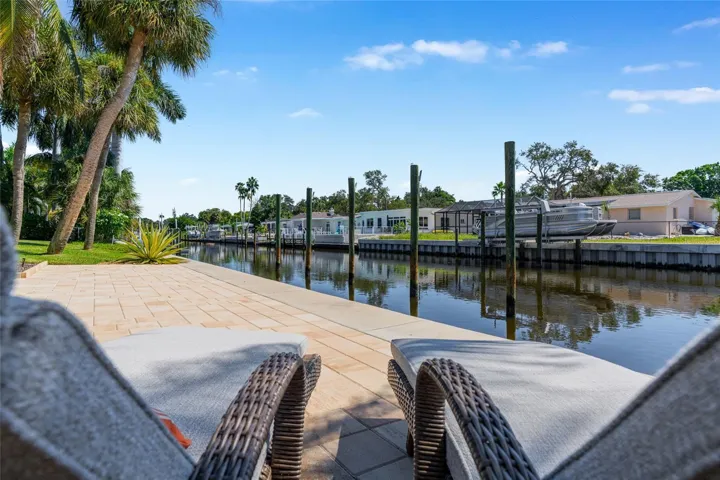 Waterfront Terrace Seating, highlighting the connection to the water and Siesta Key lifestyle.
