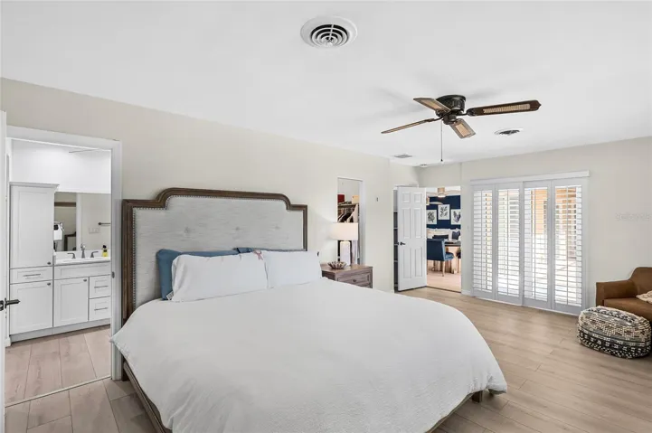 The first floor primary suite offers comfortable proportions, direct courtyard access and two walk in closets.