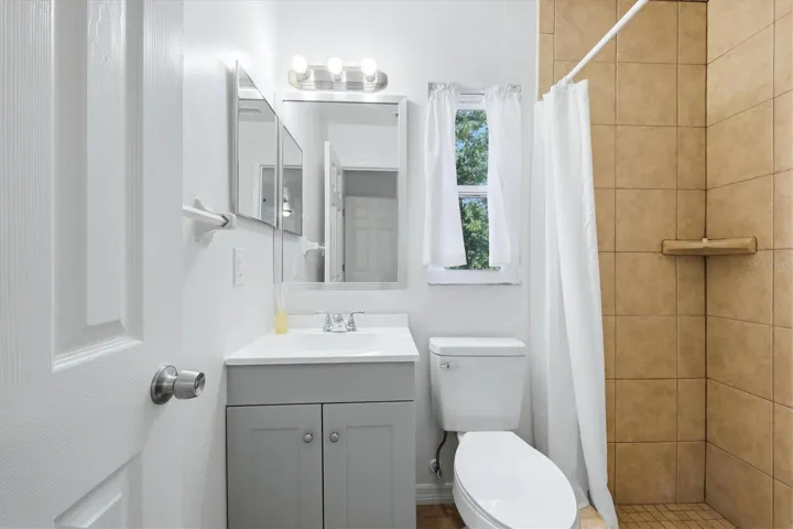 Primary bathroom has a step in shower.