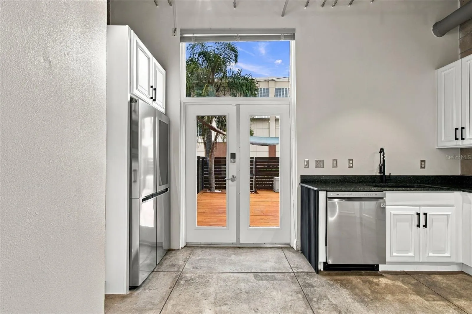 Stainless steel appliances with freshly painted cabinets and new hardware.