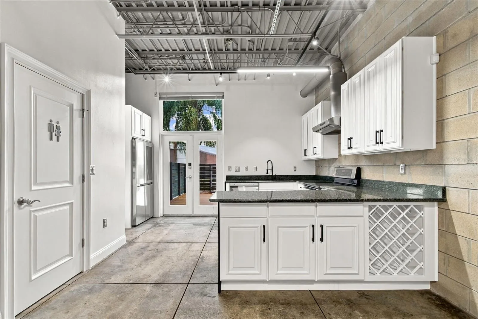 Bright, open designed kitchen looking out to the enclosed deck area.