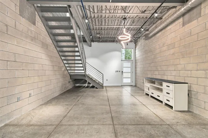 Industrial-style loft features concrete block walls and concrete flooring.