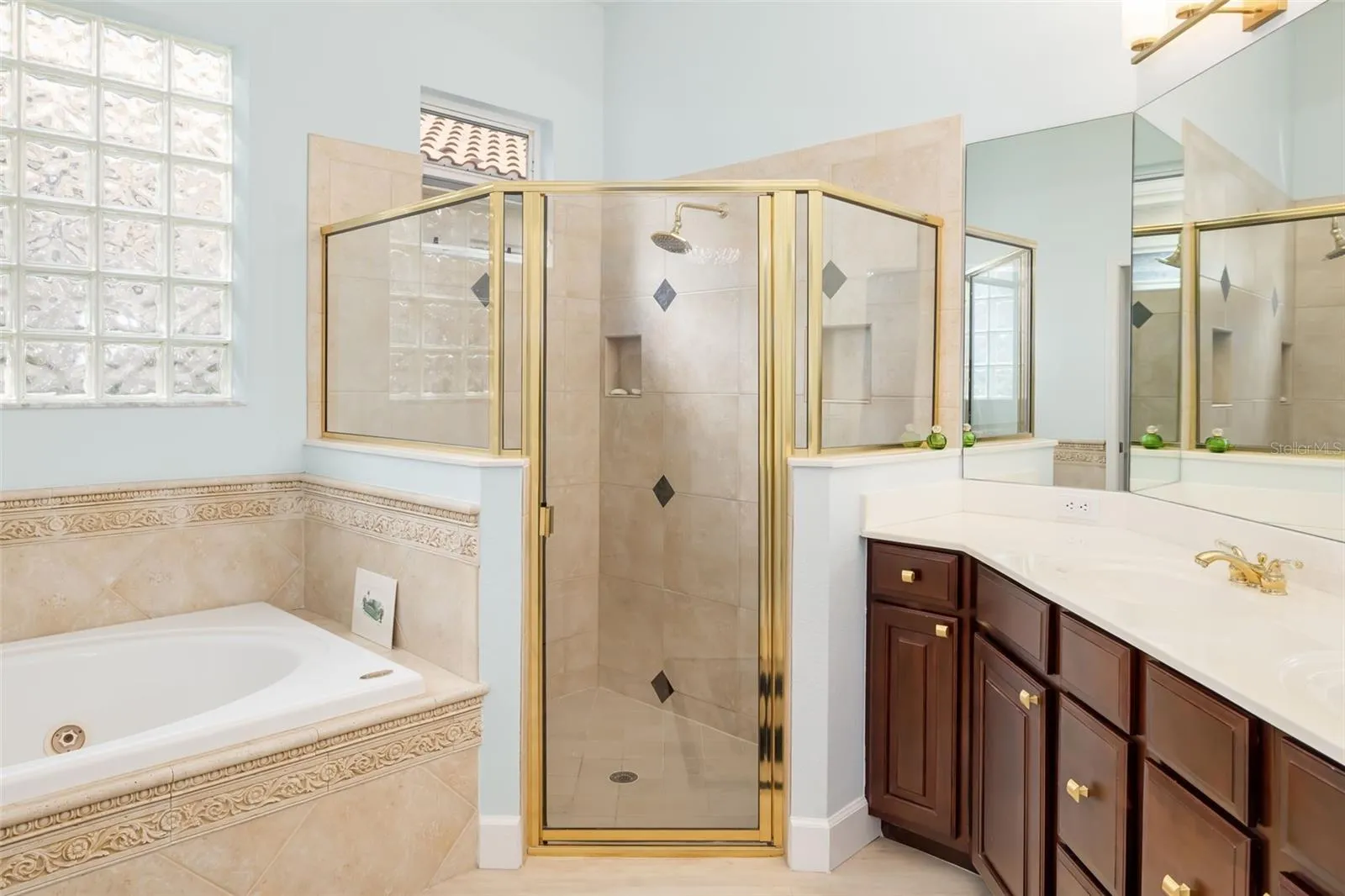 Oversized shower with built in niches. Glass block tile window lets the light through but protects your privacy.