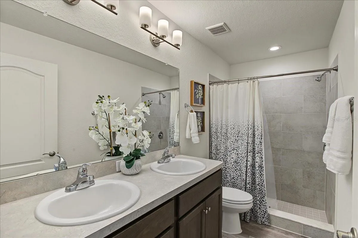 Primary Bath w/double sink, tile shower