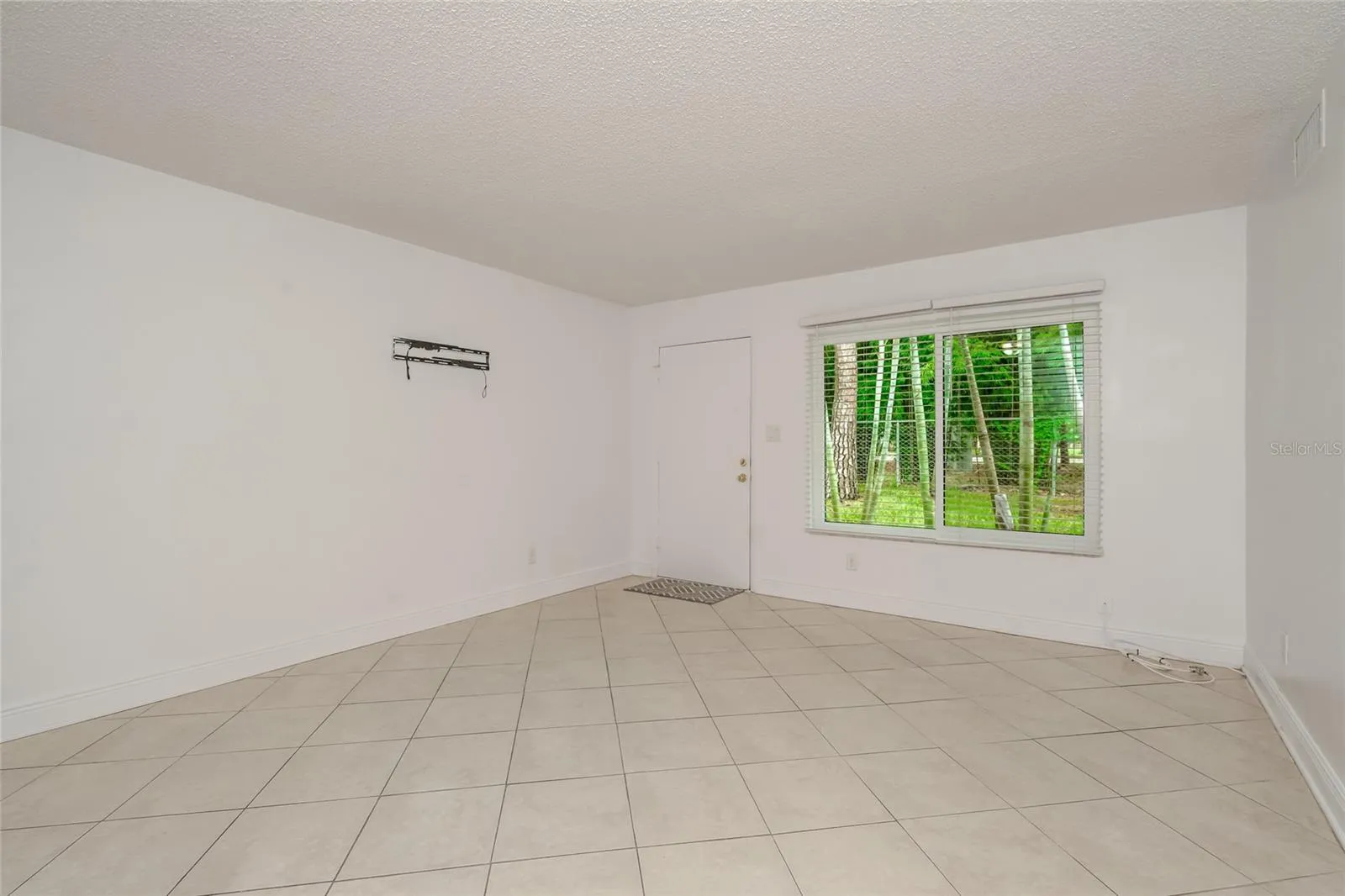501 E Bay Dr 702, Living area, view toward back of home, doorway to back patio