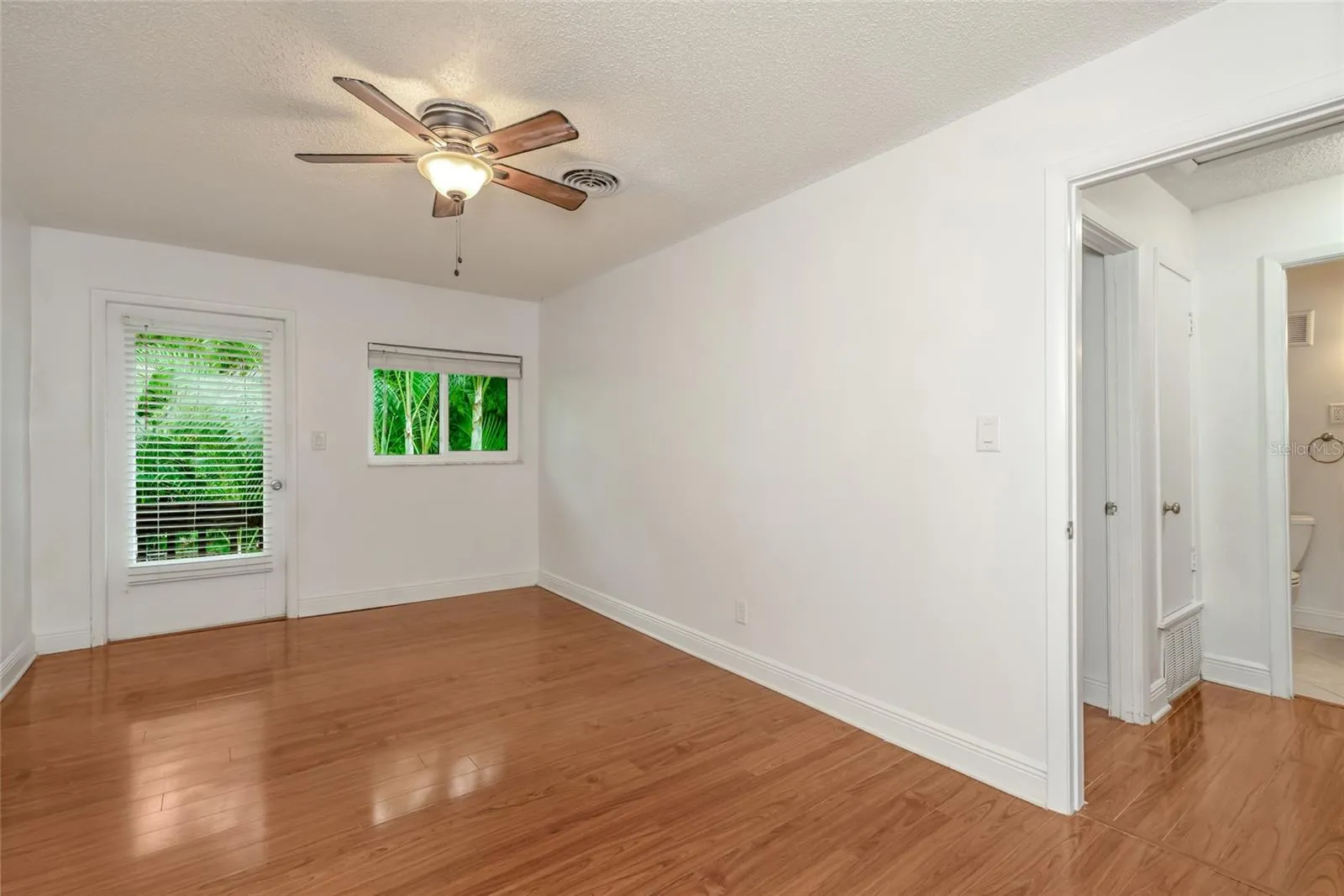 501 E Bay Dr 702, primary bedroom view toward back, door to balcony