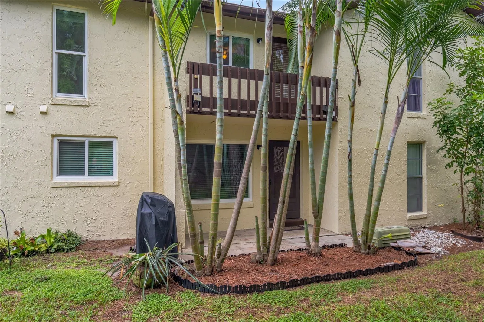 501 E Bay Dr 702, back patio, garden area and view of back of townhome