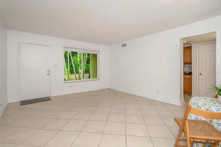 501 E Bay Dr 702, living - dining area, view from bottom of stairs toward back of living area, door to patio on left