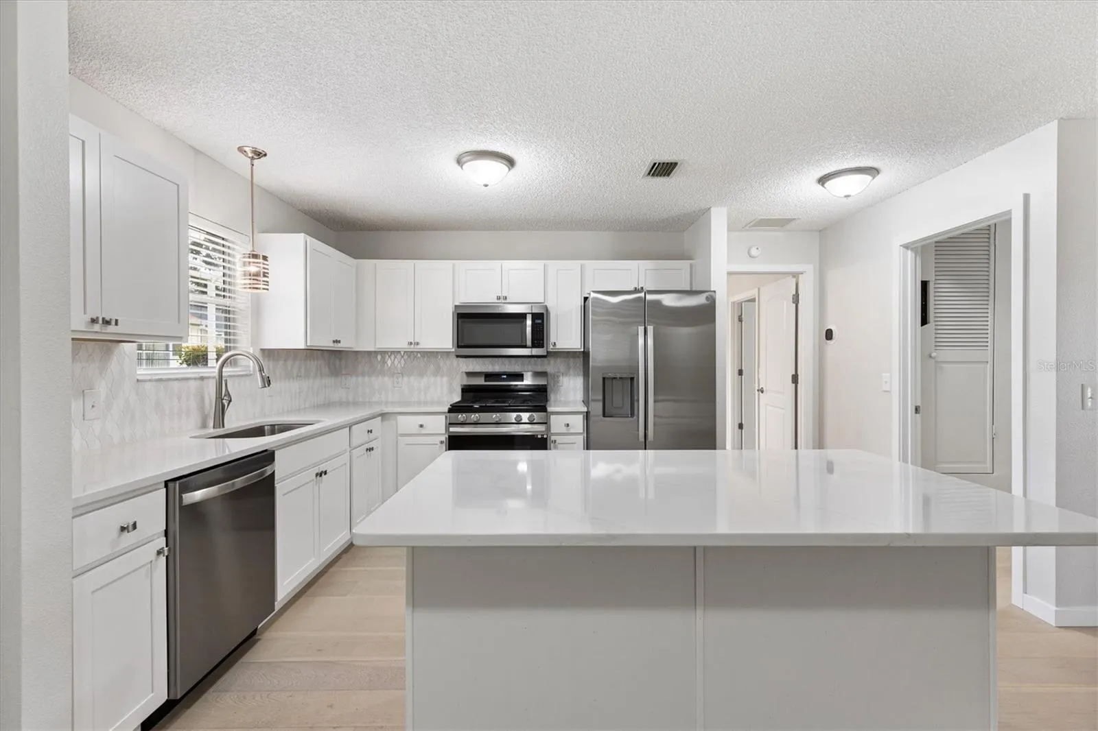 Kitchen with new Shaker Cabinets, Stainless Steel Appliances, &amp; Quartz Countertops.