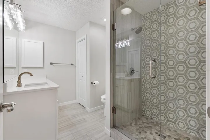 Glass Door shower and Quartz countertops enhance the Primary Ensuite.