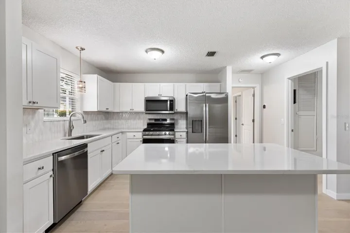 Kitchen with new Shaker Cabinets, Stainless Steel Appliances, &amp; Quartz Countertops.