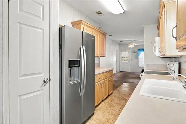Galley Kitchen with Stainless Fridge