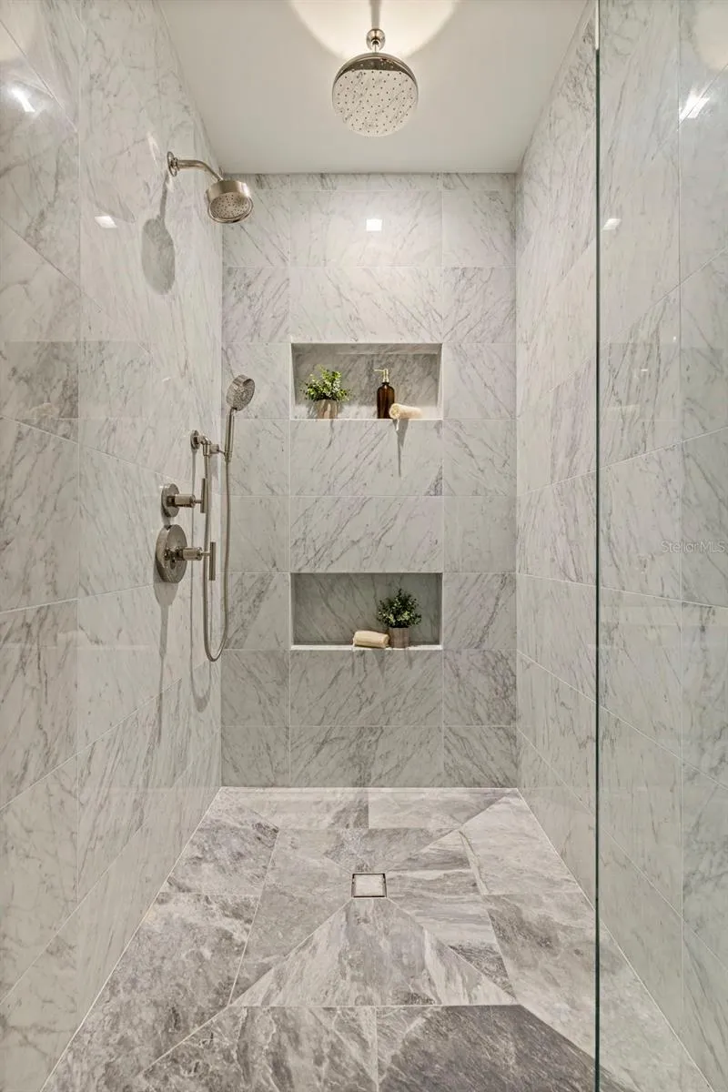 An oversized marble shower designed with a true resort-level feel.