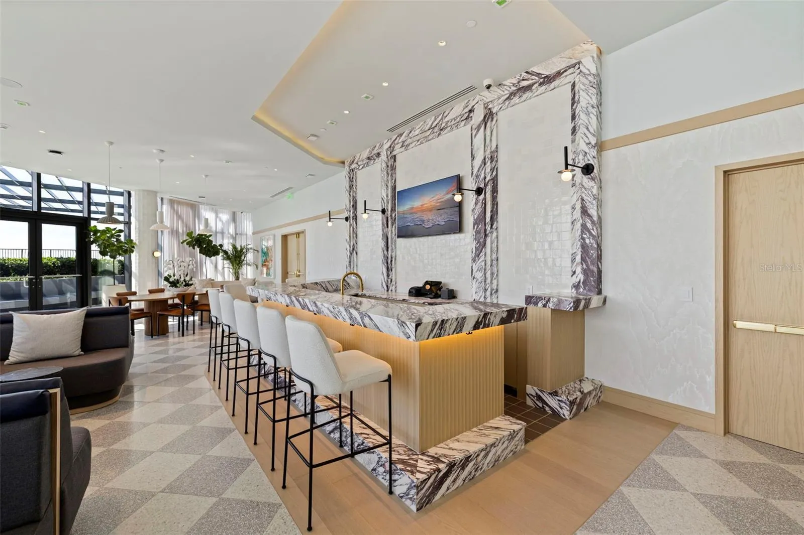 A beautifully appointed bar anchors one of the residences’ signature social spaces.