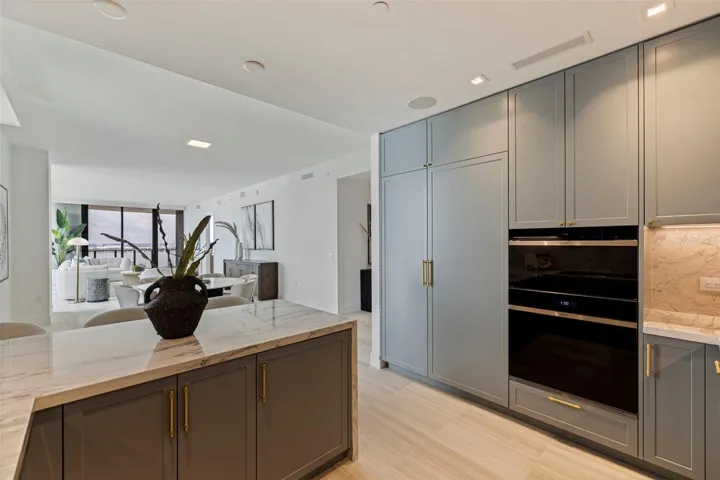 A chef-caliber kitchen with Sub-Zero and Wolf appliances, island wine refrigeration, and under-sink water purification.
