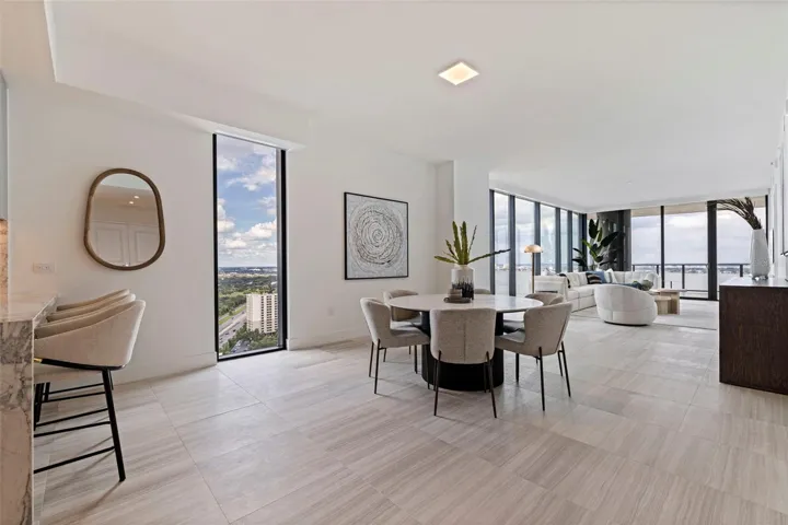 Open-concept living framed by floor-to-ceiling glass and elevated views.