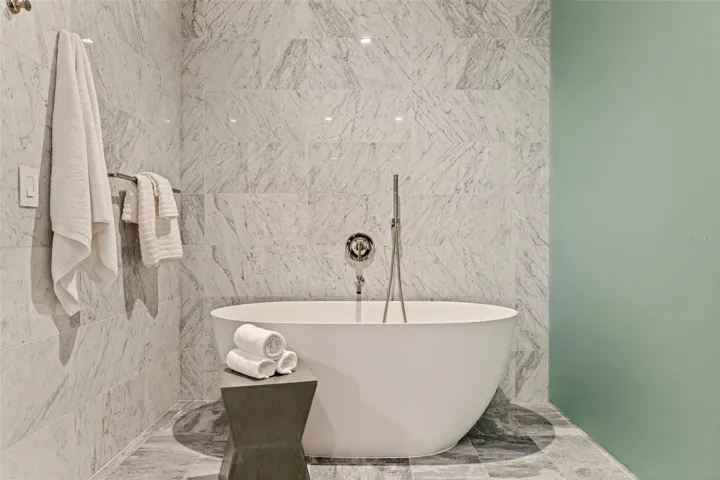 A sculptural soaking tub makes the primary bath feel distinctly spa-like.
