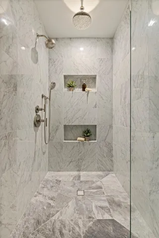 An oversized marble shower designed with a true resort-level feel.