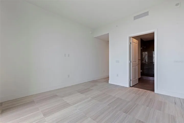 Bedroom 3 offers its own private bath, generous natural light, and a peaceful sense of separation.