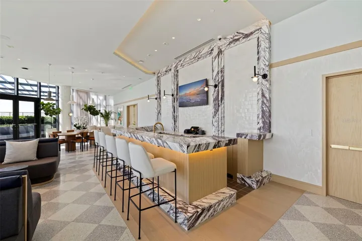 A beautifully appointed bar anchors one of the residences’ signature social spaces.