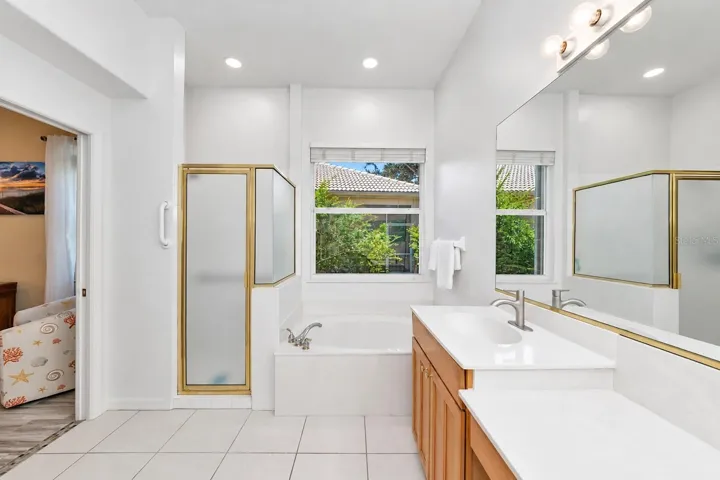 Primary suite shower and separate tub.