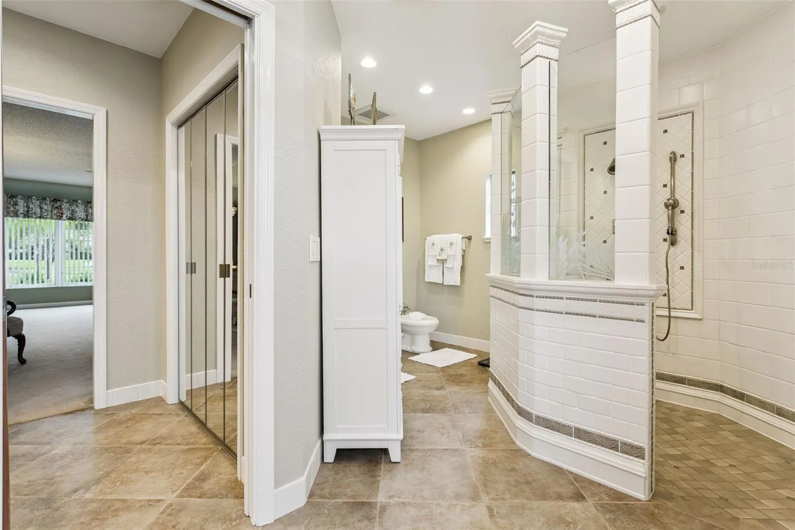 Primary bath water closet features luxurious a walk-in shower, a bidet and comfort-height toilet