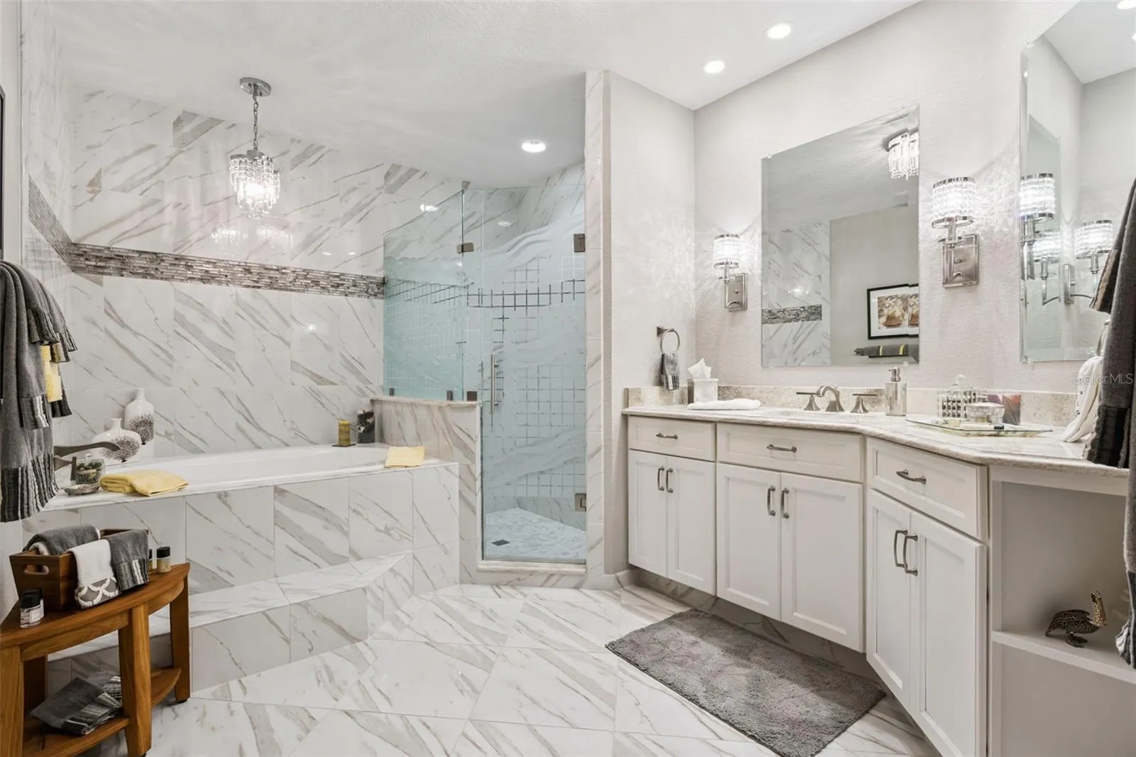 Luxurious Guest Bath with a Oversized Vanity, Luxurious Garden Tub with Decorative tile surround and Walk-in Shower with Glass Enclosure