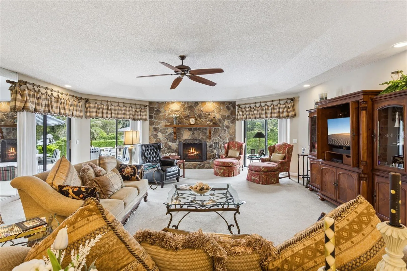 The Living room offers 3 sets of glass sliding doors overlook the patio and pool area, bringing the outdoors in and creating a seamless connection between the interior and exterior living spaces