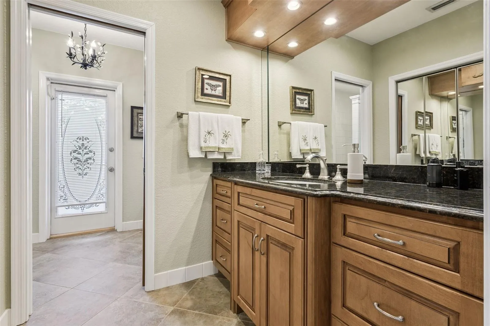 Primary bath offers a linen closet and a convenient access door leads directly to the patio