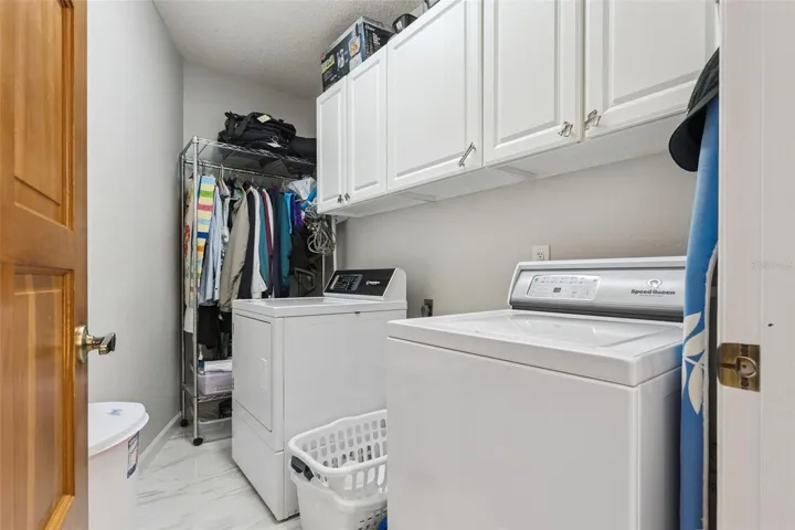 Laundry Room features overhead cabintry