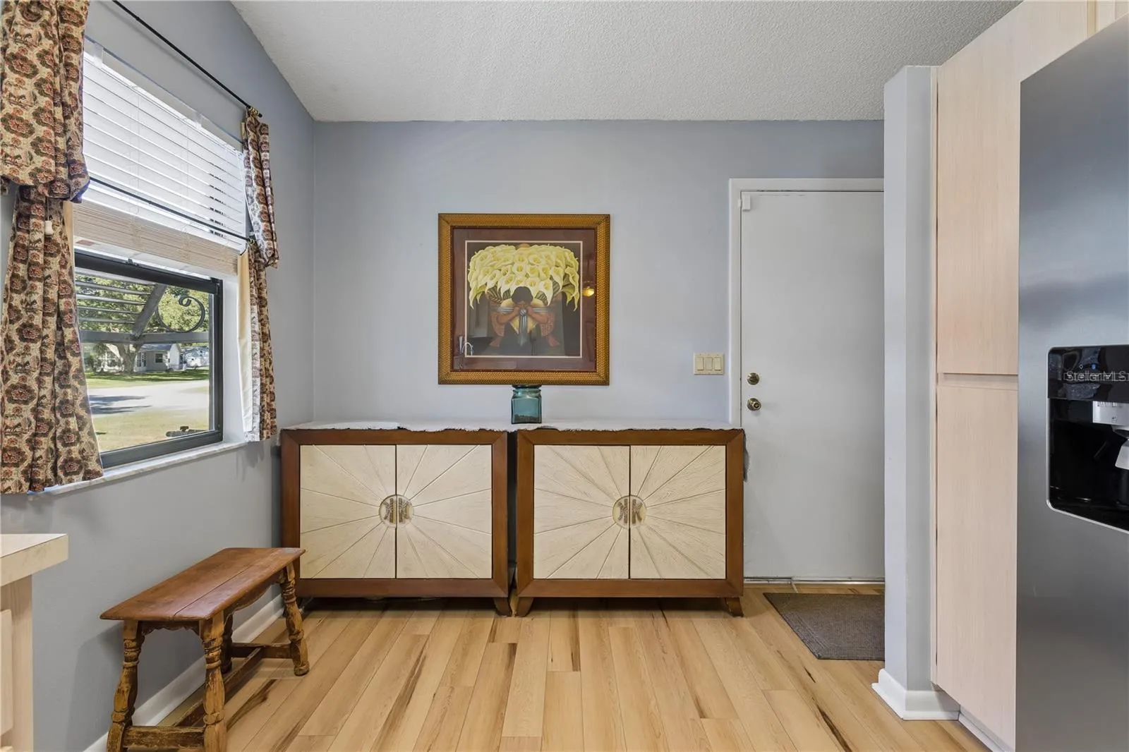 Entry from the living room into the kitchen.  Door leads to the garage.