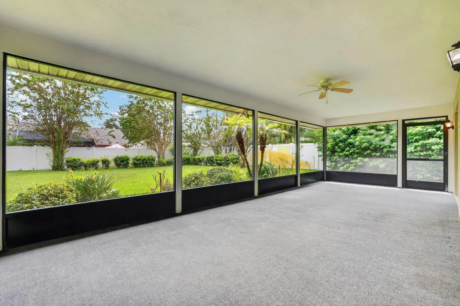 large covered and screened lanai looks out over the peaceful landscape