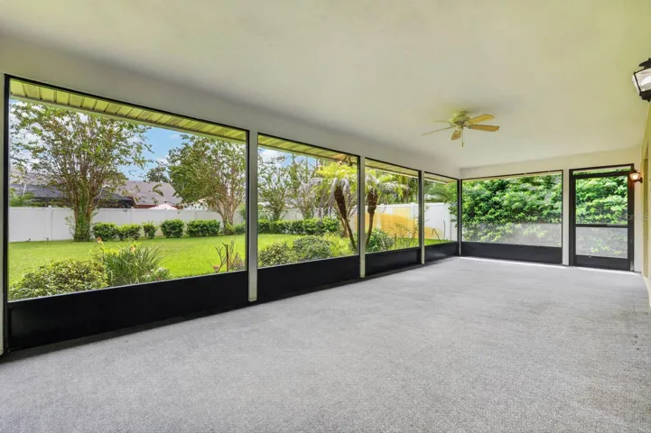 large covered and screened lanai looks out over the peaceful landscape