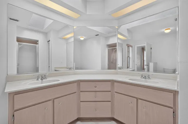Primary bathroom has double vanity sink marble countertop