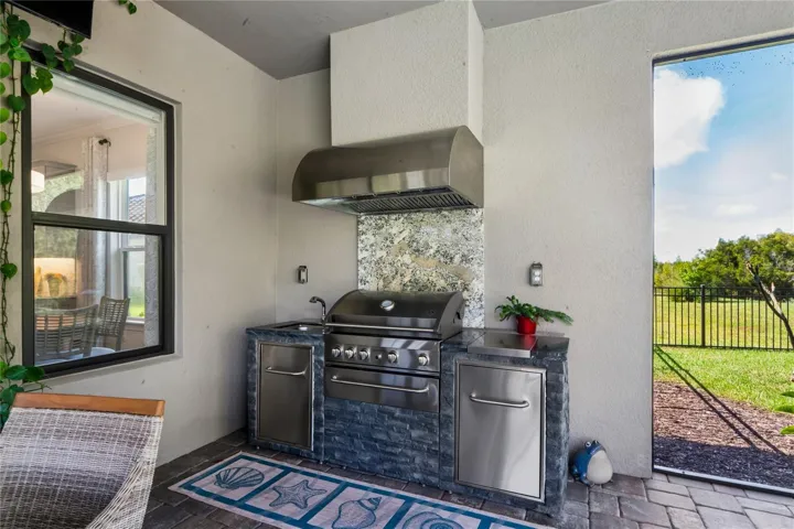 Outdoor kitchen gas grill with hood and sink
