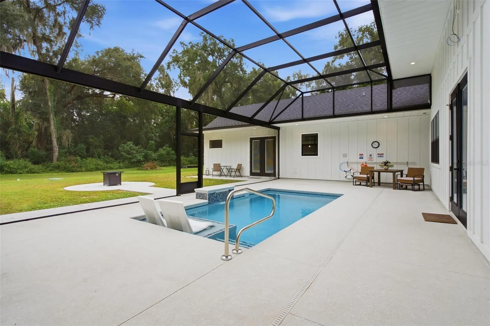 Screened pool with path leading to guest house