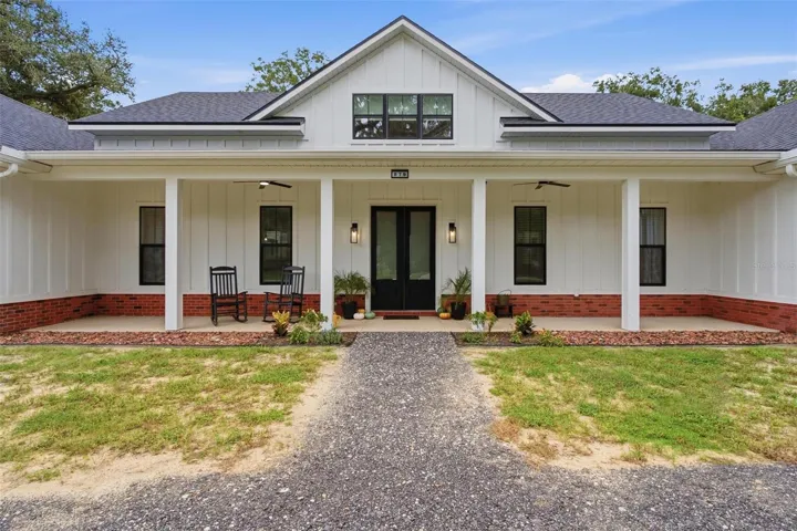 Beautiful front covered porch with double door entry