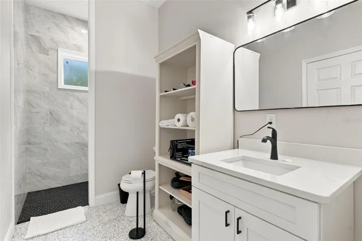Garage full bathroom that connects to pool