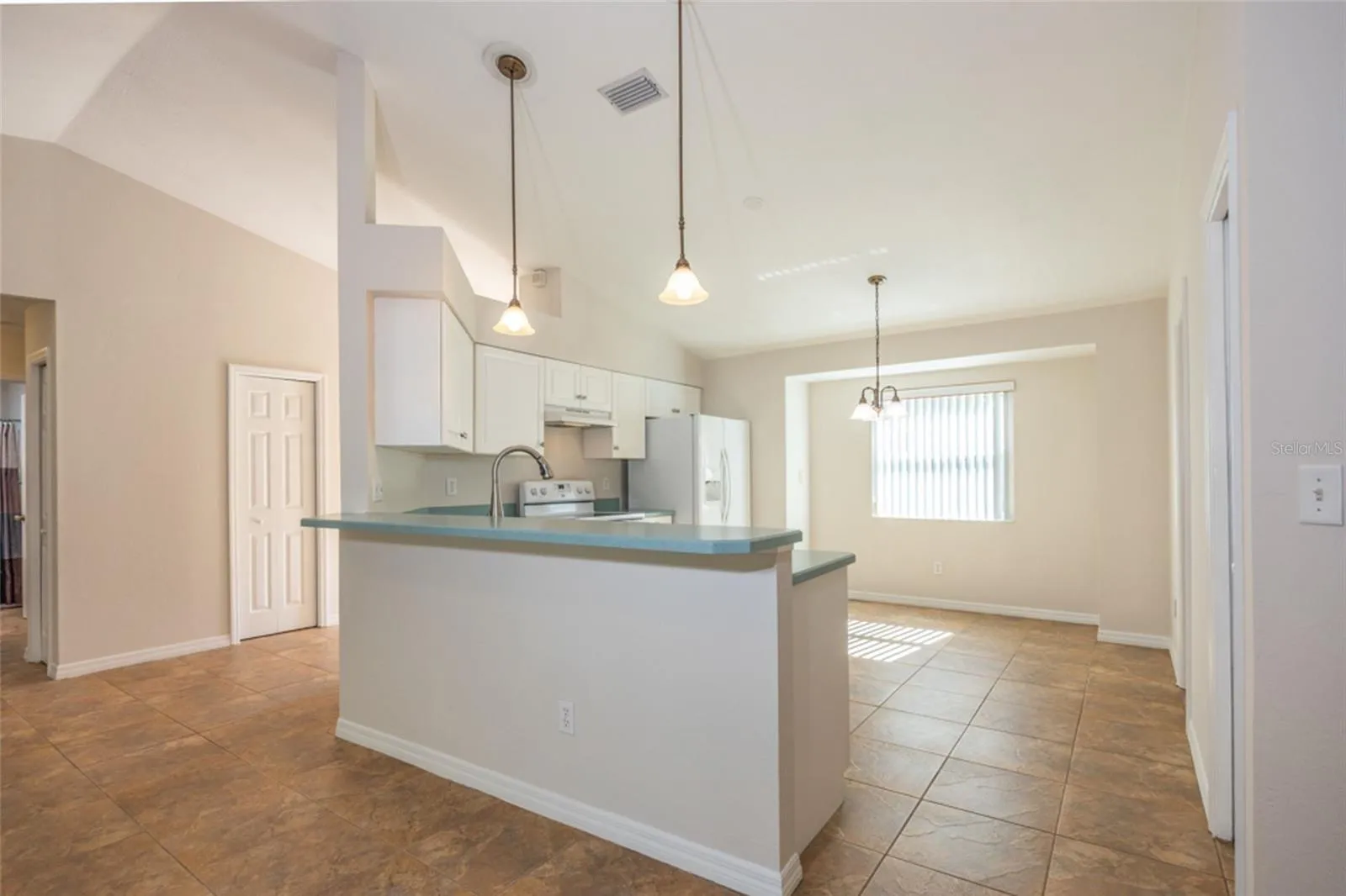 The kitchen is adjacent to the living room.  To the left is a storage closet in the Foyer.