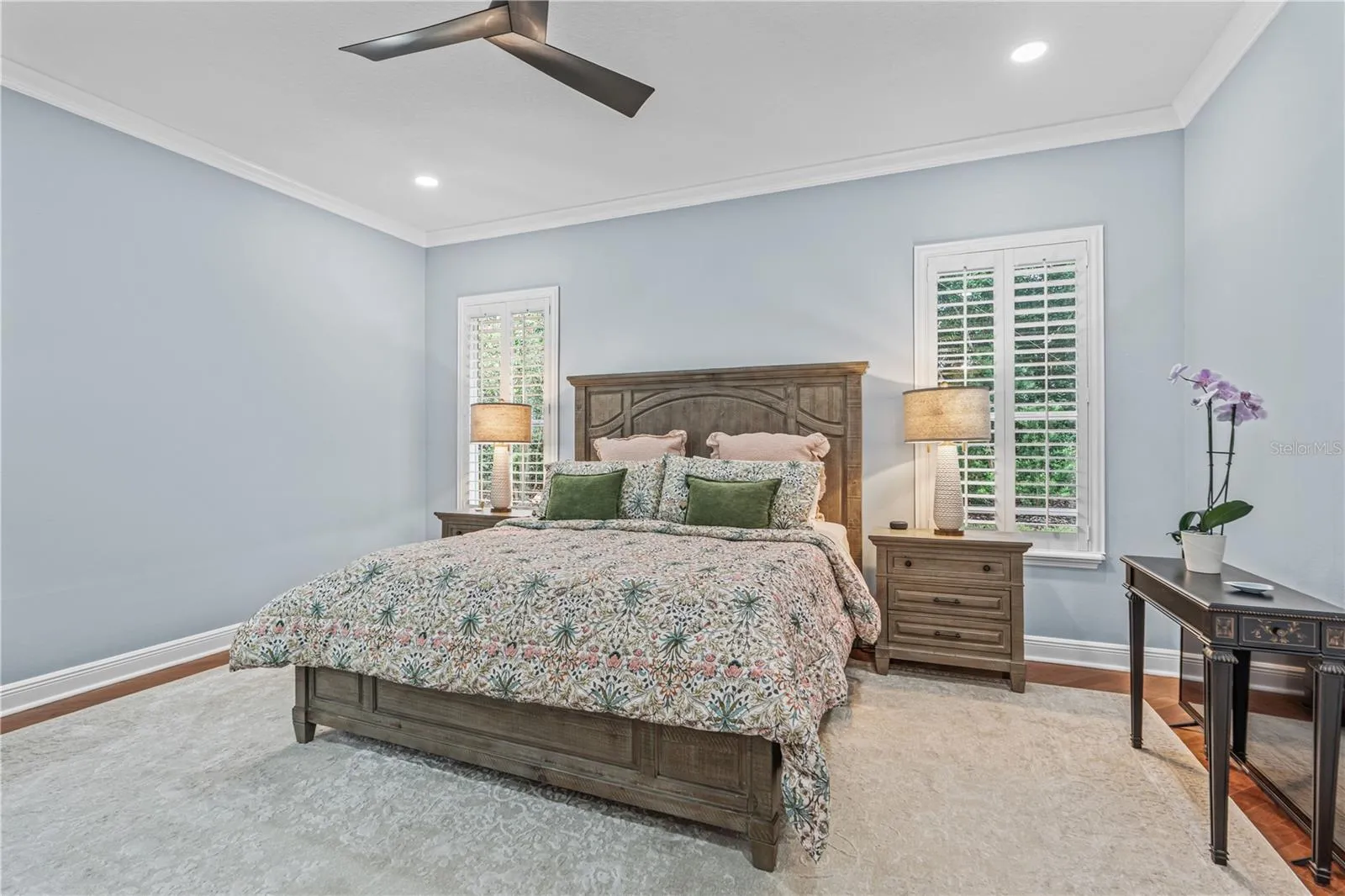 The primary bedroom windows overlook the back yard-- which is very private due to mature landscaping and trees