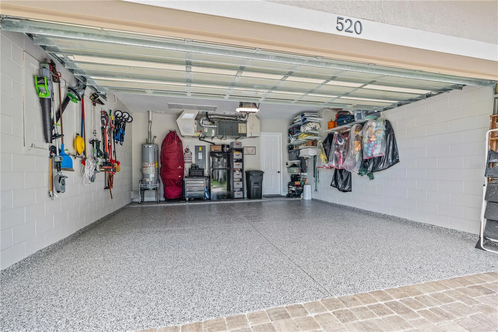 Epoxy-coated garage floor is immaculate; The "myQ" wifi-enabled garage door opener &amp; entry pad with integrated camera (not shown in this picture) convey